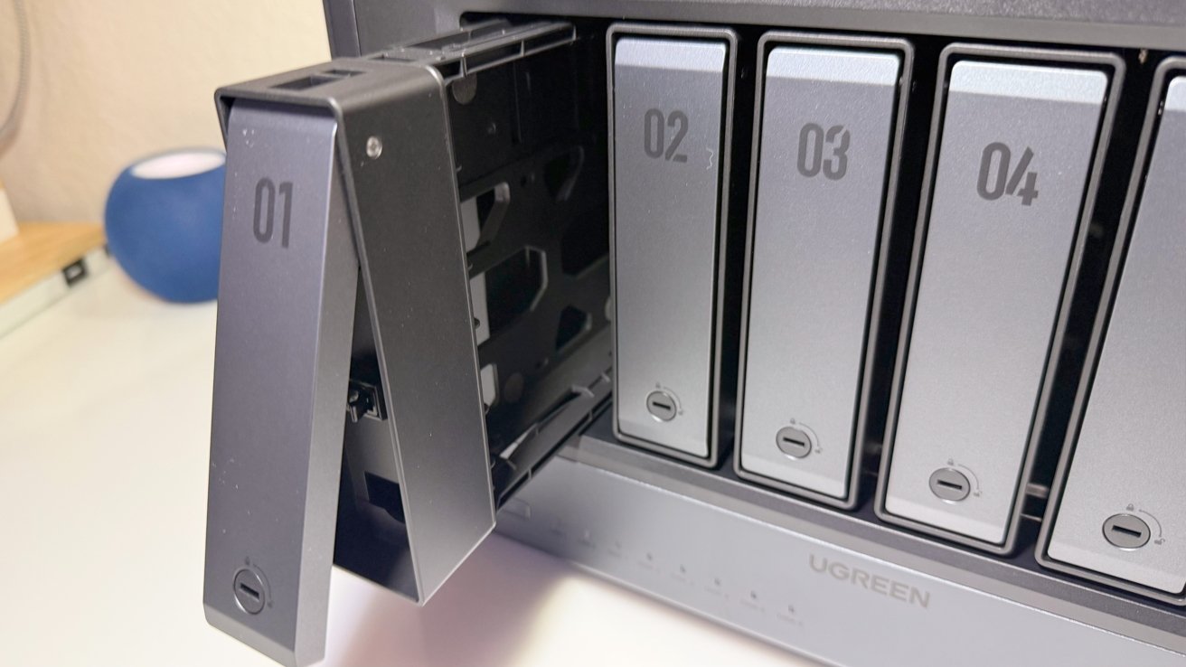 Ugreen iDX6011 Pro with bay 01 tray open, showing hot-swappable drive mechanism